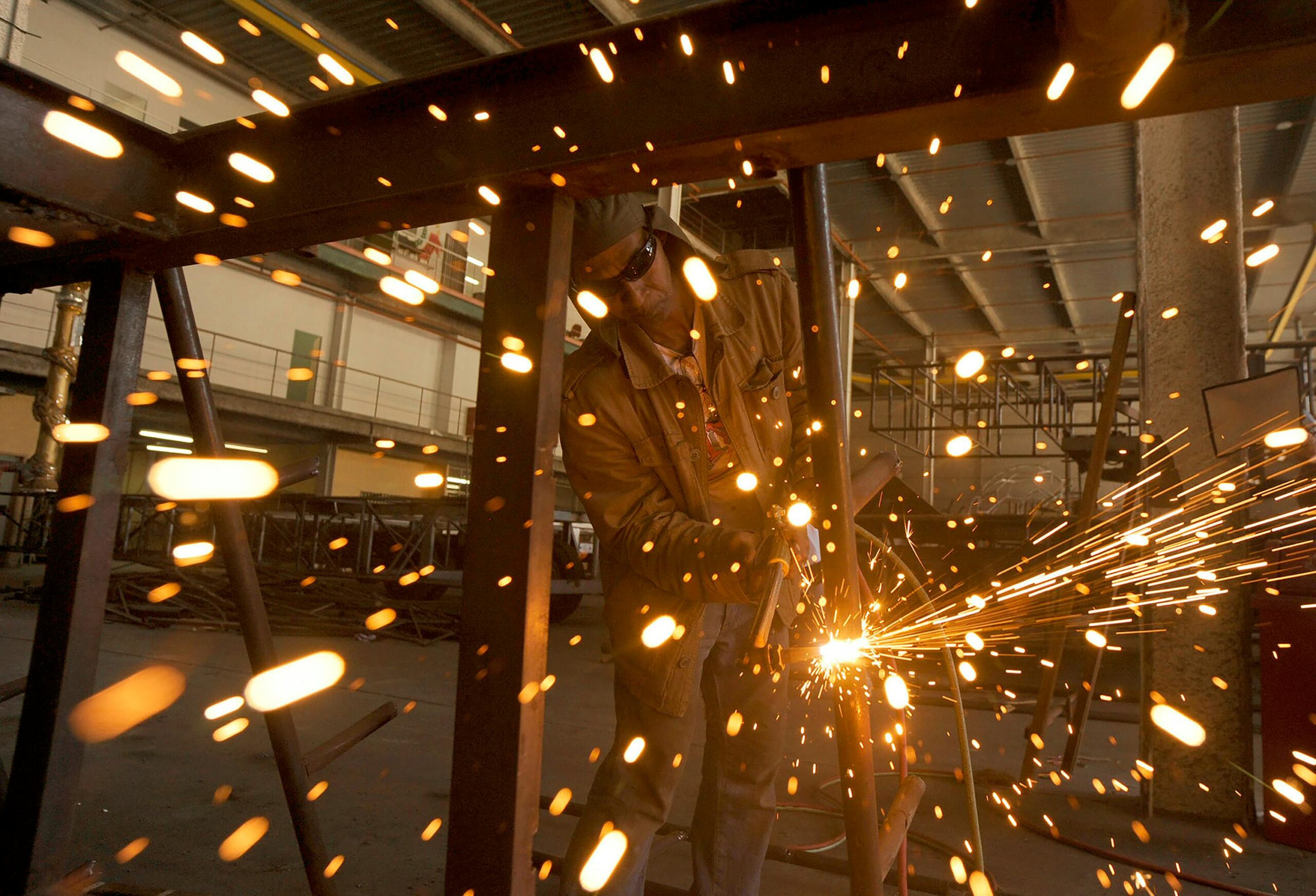 Accueil A welder sparks in an industrial workshop in Rio de Janeiro, Brazil.